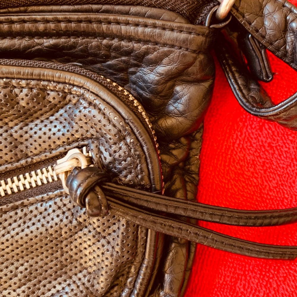 Small, black, purse with zippers.